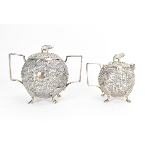 58 - A late 19th/early 20th century Indian white metal three piece tea service, consisting of a teapot, s... 