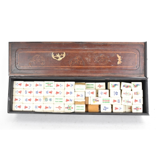 61 - An early 20th century Chinese Mah Jong set, contained in an ebonised case with an inlaid lid with bo... 