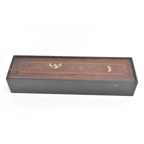 61 - An early 20th century Chinese Mah Jong set, contained in an ebonised case with an inlaid lid with bo... 