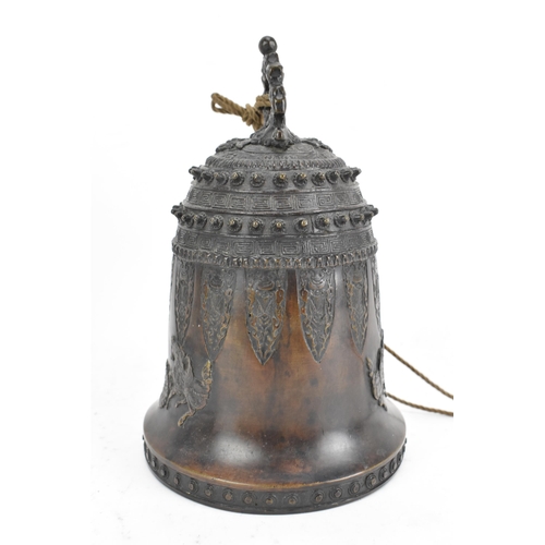 72 - A 19th century Burmese bronze temple bell, decorated with rows of leaf tip studs, Grecian key border... 