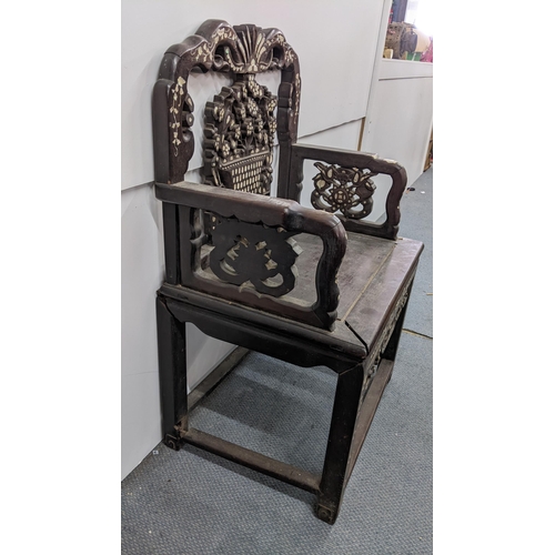 73 - A Chinese Qing dynasty hardwood armchair, having a pierced carved splat in the form of a basket of f... 