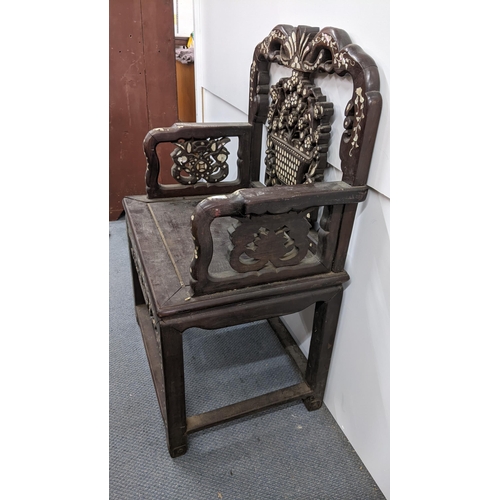 73 - A Chinese Qing dynasty hardwood armchair, having a pierced carved splat in the form of a basket of f... 