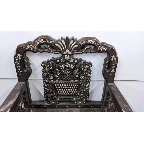 73 - A Chinese Qing dynasty hardwood armchair, having a pierced carved splat in the form of a basket of f... 