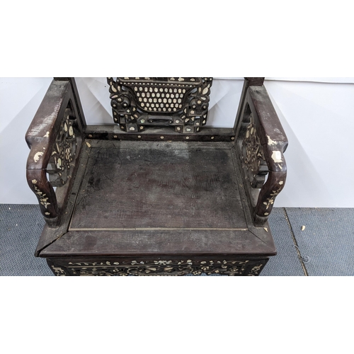 73 - A Chinese Qing dynasty hardwood armchair, having a pierced carved splat in the form of a basket of f... 