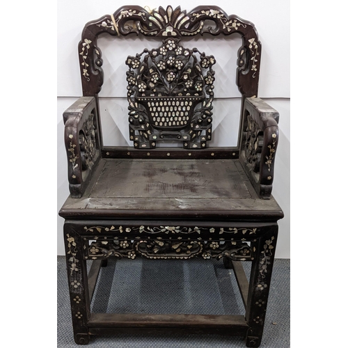 74 - A Chinese Qing dynasty hardwood armchair, having a pierced carved splat in the form of a basket of f... 