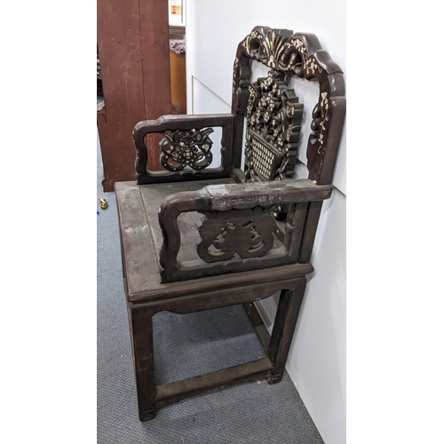 74 - A Chinese Qing dynasty hardwood armchair, having a pierced carved splat in the form of a basket of f... 