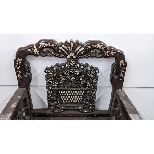 74 - A Chinese Qing dynasty hardwood armchair, having a pierced carved splat in the form of a basket of f... 