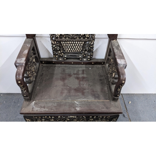 74 - A Chinese Qing dynasty hardwood armchair, having a pierced carved splat in the form of a basket of f... 