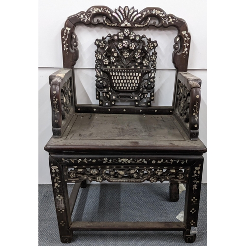 75 - A Chinese Qing dynasty hardwood armchair, having a pierced carved splat in the form of a basket of f... 