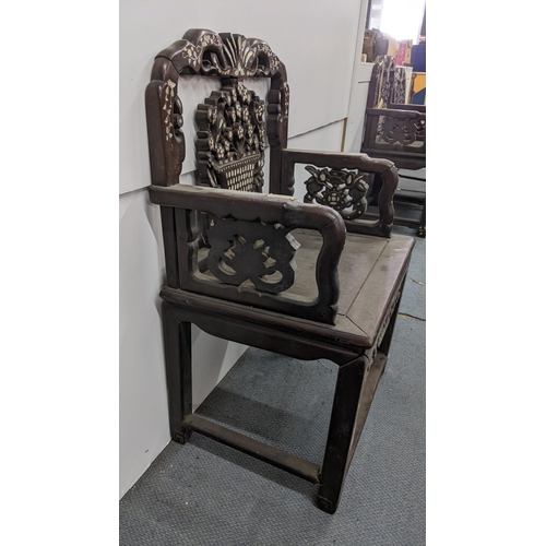 75 - A Chinese Qing dynasty hardwood armchair, having a pierced carved splat in the form of a basket of f... 