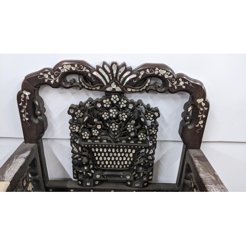 75 - A Chinese Qing dynasty hardwood armchair, having a pierced carved splat in the form of a basket of f... 