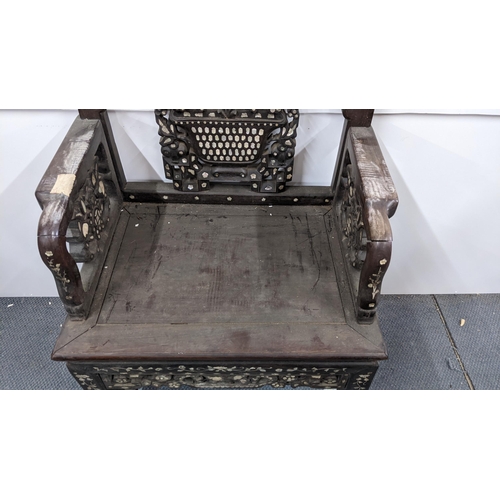 75 - A Chinese Qing dynasty hardwood armchair, having a pierced carved splat in the form of a basket of f... 