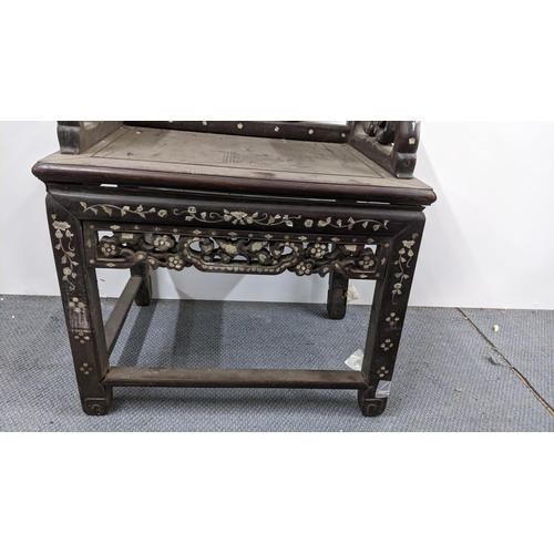 75 - A Chinese Qing dynasty hardwood armchair, having a pierced carved splat in the form of a basket of f... 