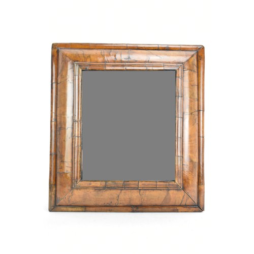 136 - A William and Mary walnut veneered mirror, circa 1690, the later plain mirror plate within a cushion... 