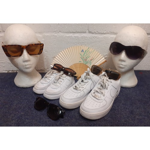 107 - A mixed lot comprising fashion sunglasses to include Wayfarer style glasses, a pair of white Nike Ai... 