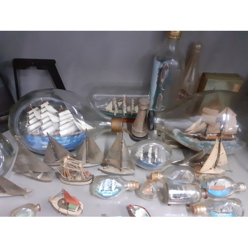 238 - A quantity of model ships in glass bottles to include a Cutty Sark model together with silver plated... 