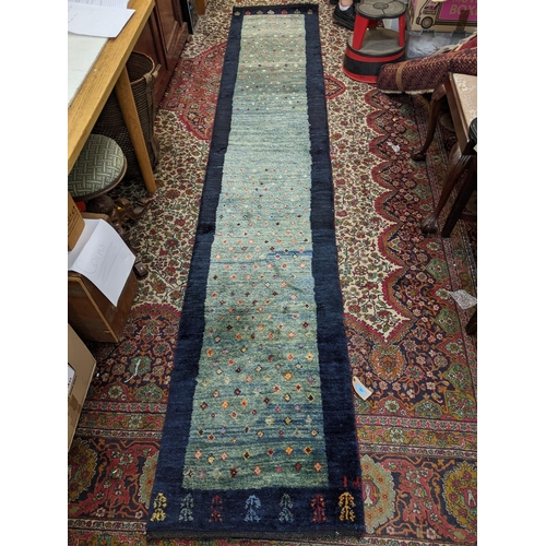 161 - An Iranian Gabbeh runner with repeated motif on a mottled blue ground 330cm x 62cm
Location:A4B FLOO... 