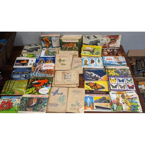 110 - A collection of collectors cards in books and various cigarette cards to include National Flags & Ar... 