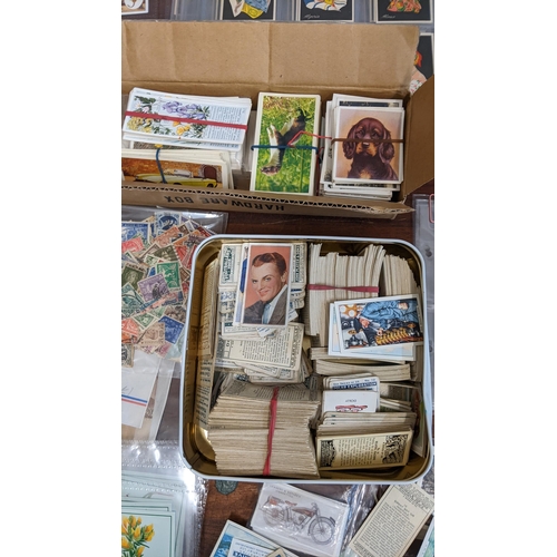 110 - A collection of collectors cards in books and various cigarette cards to include National Flags & Ar... 