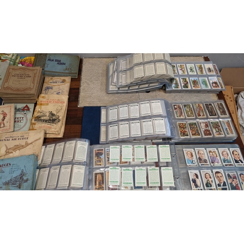 113 - A selection of collectors cards, some in books, others in albums, to include Hints on Association Fo... 