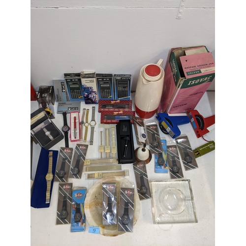 13 - Vintage collectable to include calculators, wristwatches in original packaging, a lighter in the for... 