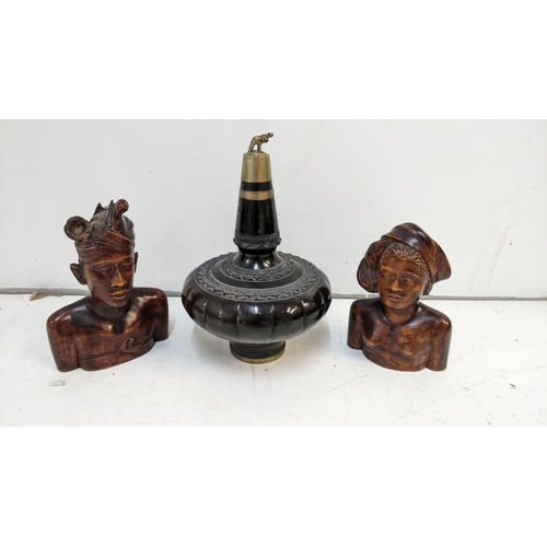 15 - An ebony and brass carved wine bottle along with two carved busts of a lady and a man
Location:1.5
I... 