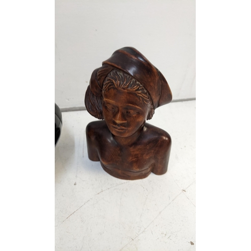 15 - An ebony and brass carved wine bottle along with two carved busts of a lady and a man
Location:1.5
I... 