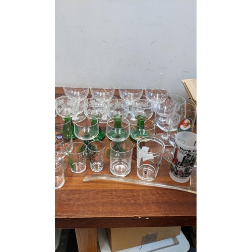 189 - A collection of glassware to include mostly drinkware to include German themed 1/2 litre beer glasse... 