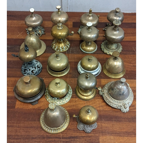 22 - A collection of brass reception bells, mostly on brass and metal plinths, one on a ceramic plinth
Lo... 