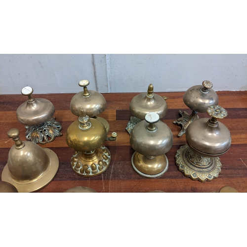 22 - A collection of brass reception bells, mostly on brass and metal plinths, one on a ceramic plinth
Lo... 