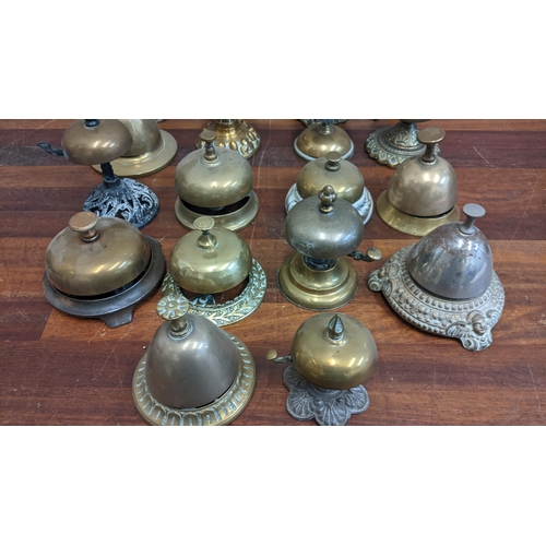 22 - A collection of brass reception bells, mostly on brass and metal plinths, one on a ceramic plinth
Lo... 