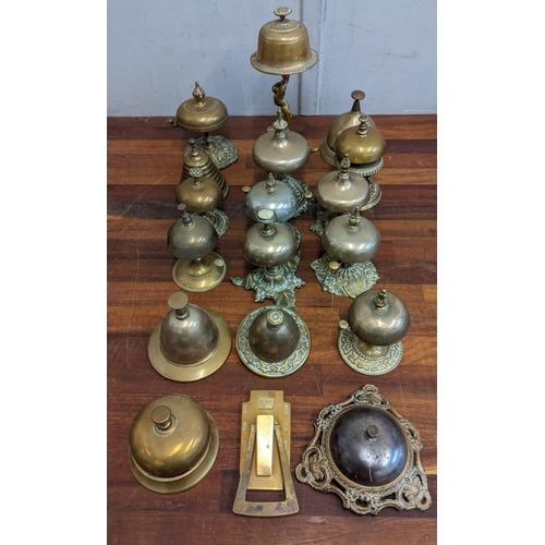 23 - A collection of brass reception bells with various different designs together with a door knocker
Lo... 