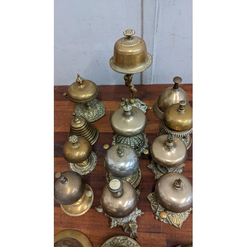 23 - A collection of brass reception bells with various different designs together with a door knocker
Lo... 