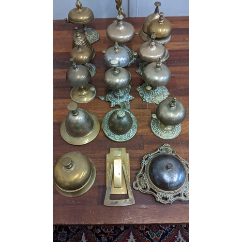 23 - A collection of brass reception bells with various different designs together with a door knocker
Lo... 