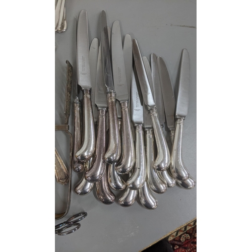 241 - A quantity of various silver plated flatware and cutlery along with asparagus servers and other item... 