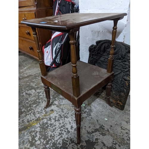 259 - A Regency mahogany two tier table standing on turned, fluted and splayed legs, the under tier with i... 