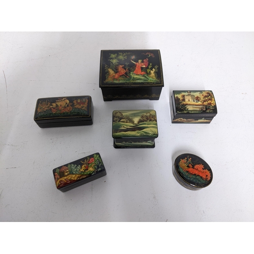 40 - A group of six Russian lacquered paper mache boxes to include a small oval box with a Troika scene t... 