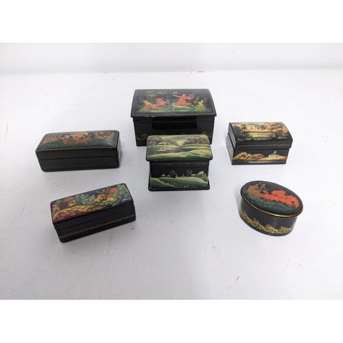 40 - A group of six Russian lacquered paper mache boxes to include a small oval box with a Troika scene t... 