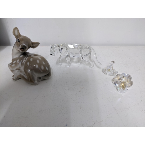 54 - A Swarovski crystal sculpture of a lioness, along with two fantail doves, and a Royal Copenhagen mod... 