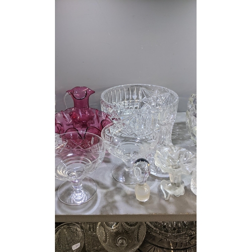 6 - A mixed lot of glassware to include crystal glass bowls, decanter vinegar jugs together with a decor... 