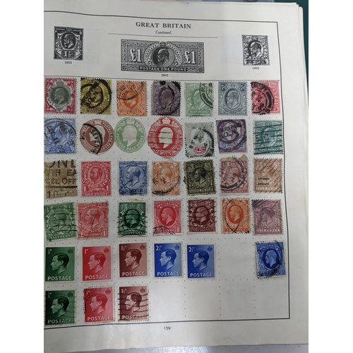 67 - A collection of world stamps and coins, held mainly in three albums, to include GB and Italy stamps ... 