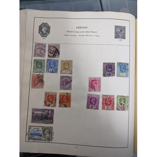 67 - A collection of world stamps and coins, held mainly in three albums, to include GB and Italy stamps ... 