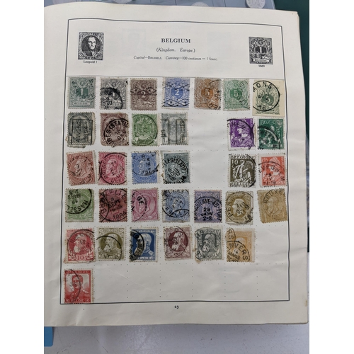 67 - A collection of world stamps and coins, held mainly in three albums, to include GB and Italy stamps ... 