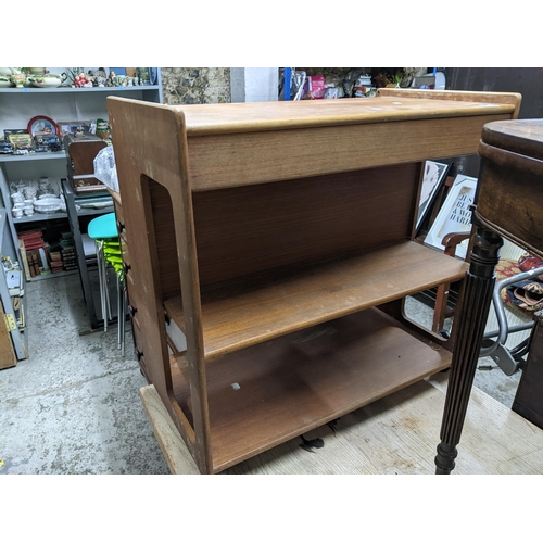 75 - A H McIntosh & Co Ltd mid-century teak tea trolley, cutlery drawer to top shelf below two further sh... 