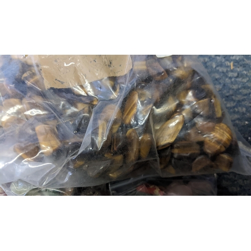 141 - Sixteen bags of semi precious stones to include tiger eye, aquamarine and others
Location:1.5
If the... 