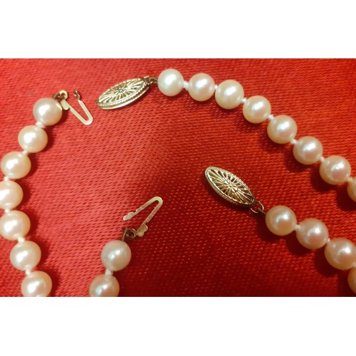 103 - A cultured pearl necklace and matching bracelet having a 14ct gold clasp, the necklace measuring 39c... 