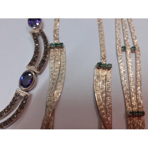 100 - Two silver jewellery suites; one with purple stones and the other with green stones, both in the ear... 