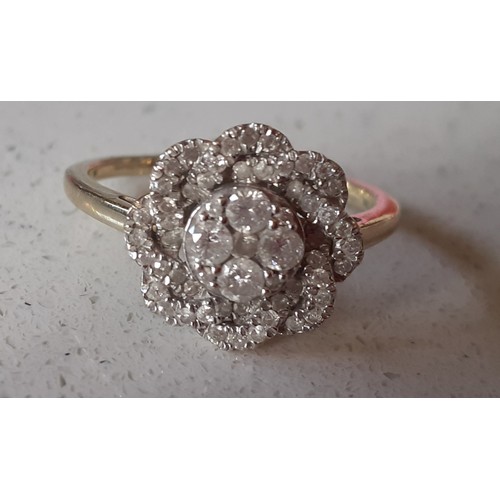 12 - A modern limited edition 9ct gold 'Tomas Rae' dress ring in a floral design with African diamonds, t... 