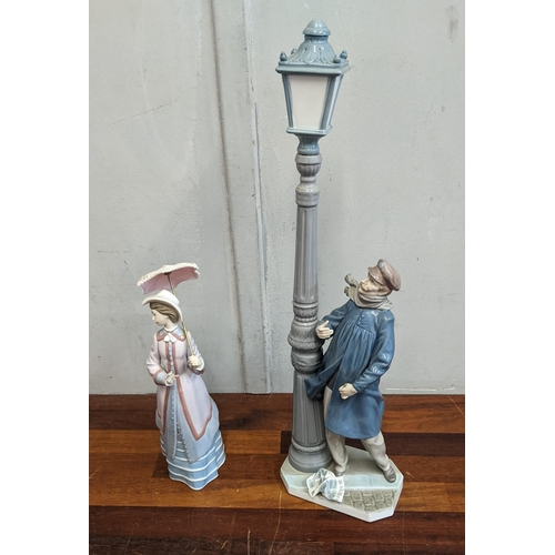 451 - Two Lladro figurines to include Lamplighter and Parisian Lady with parasol 
Location: 7.1
If there i... 