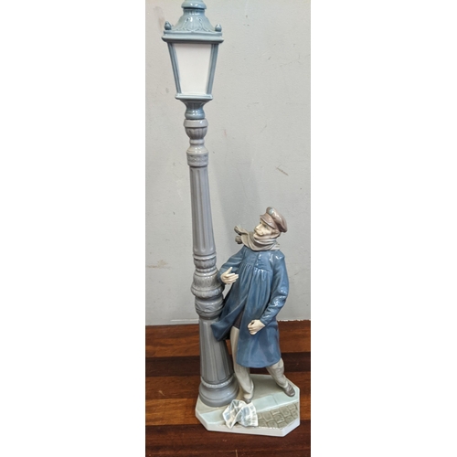 451 - Two Lladro figurines to include Lamplighter and Parisian Lady with parasol 
Location: 7.1
If there i... 